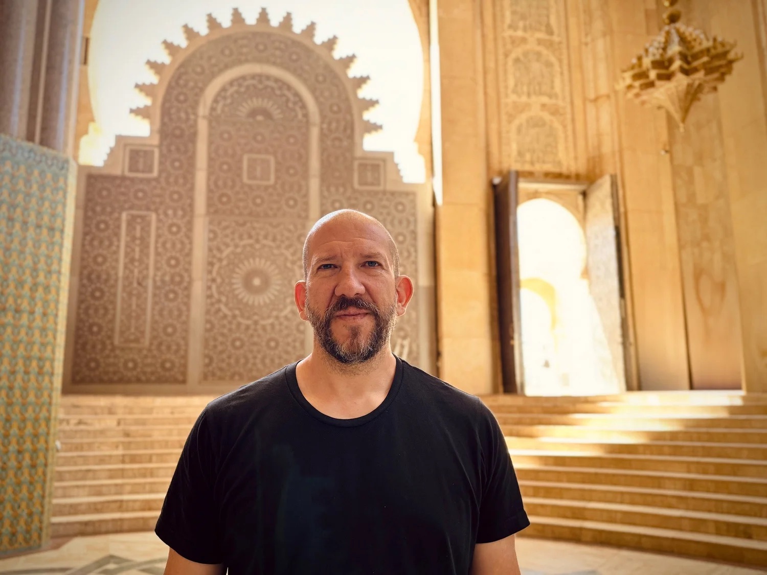 John J.A. Jannone, standing in front of a carved stone doorway
