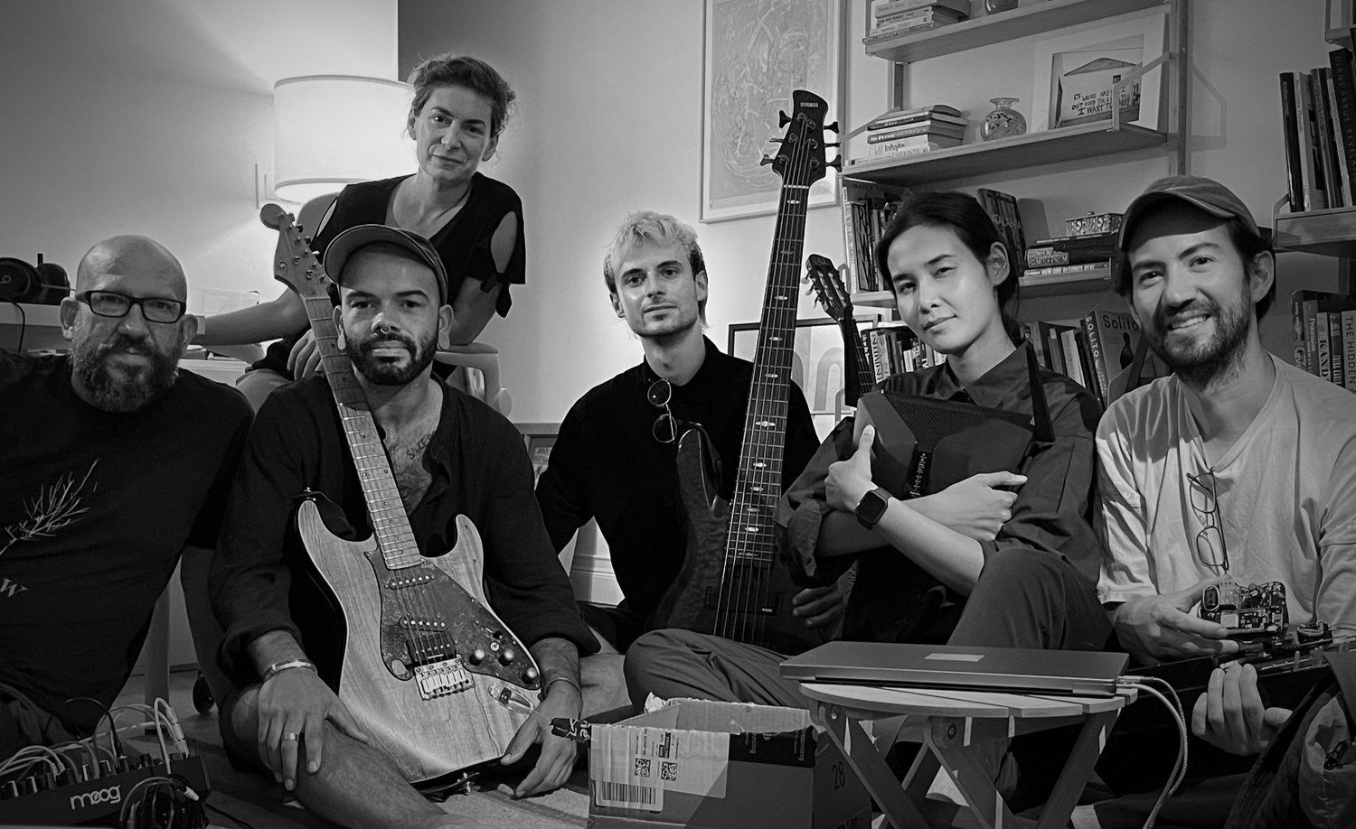 Black-and-white group photo of salon musicians with their instruments